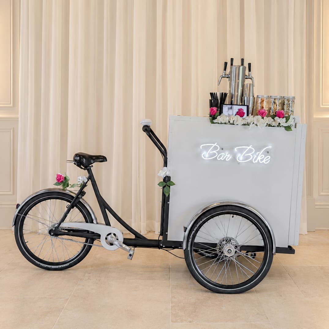 BarBike cocktail tricycle decorated with pink and white flowers